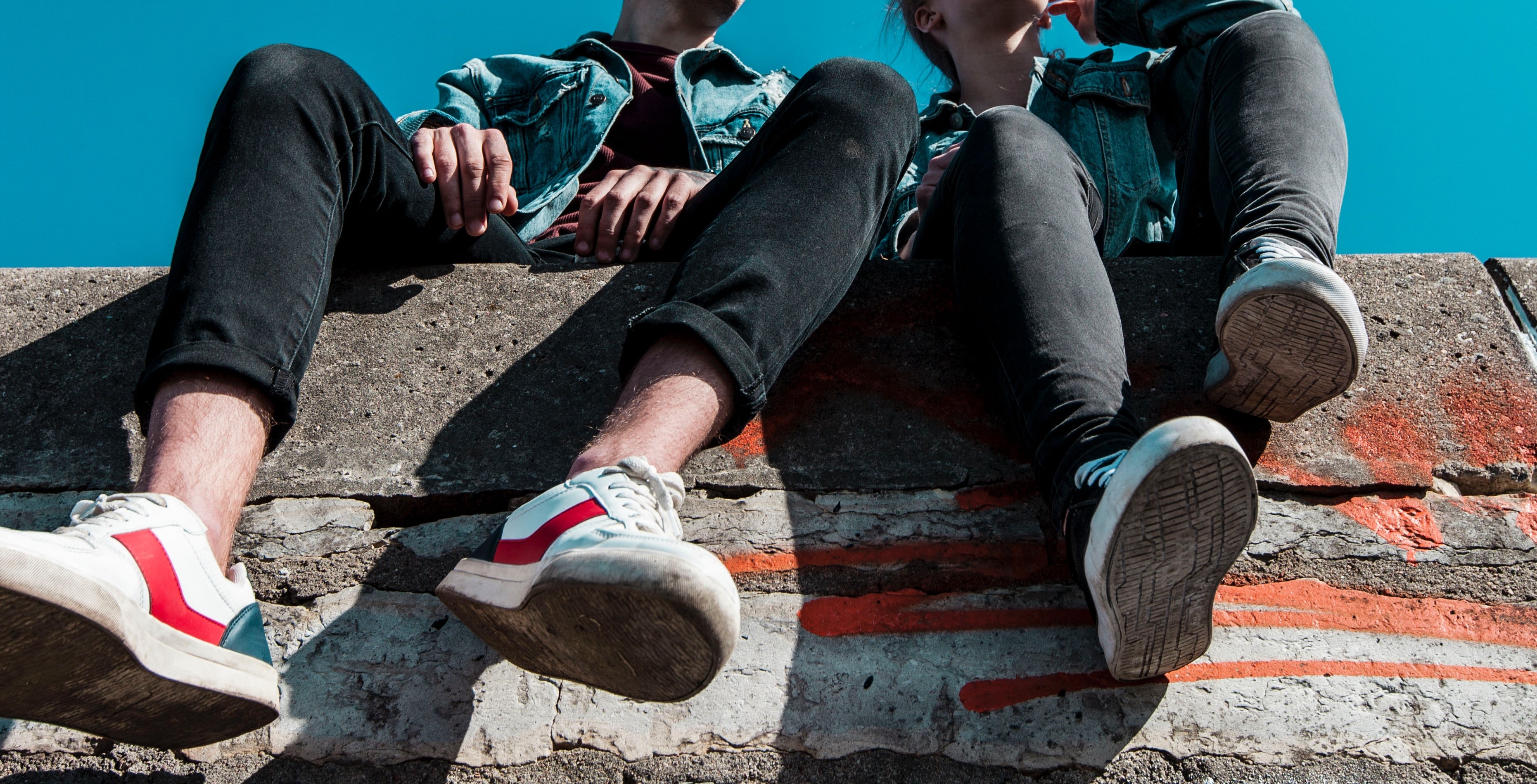 young people sitting on a wall