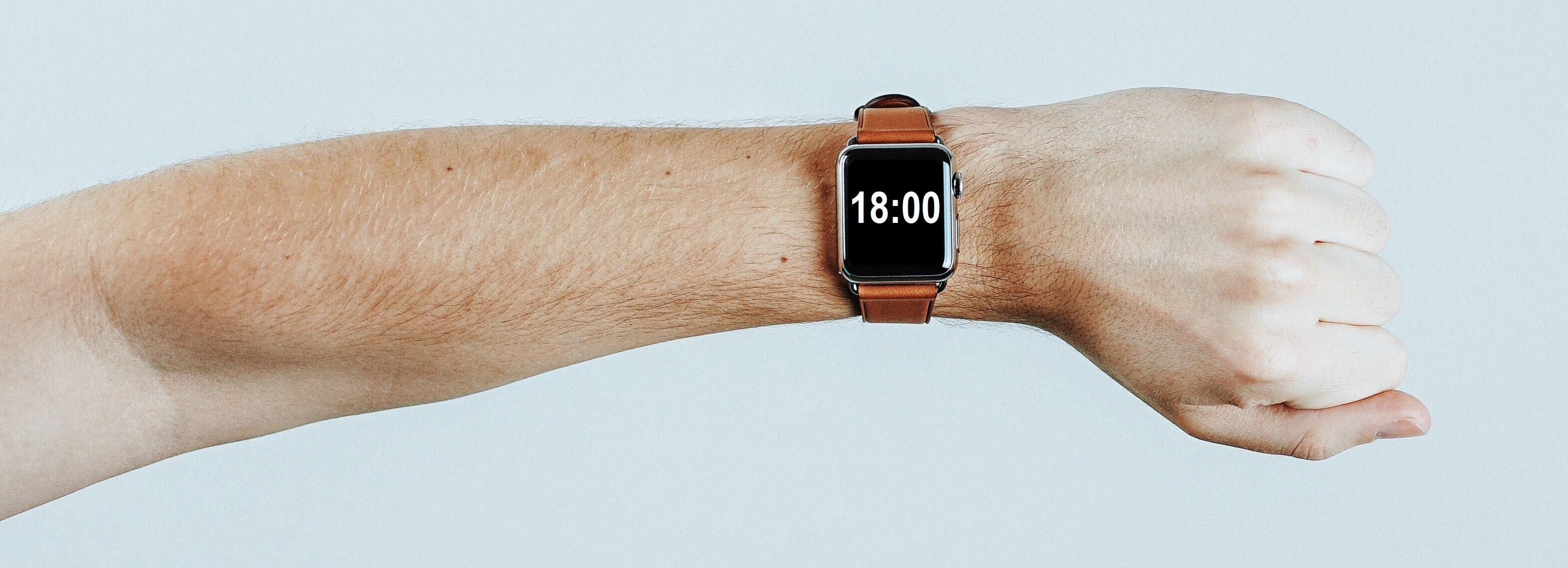 arm wearing watch reading 1800
